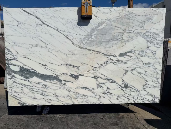 Marble slab with a white and gray pattern on an outdoor setting in los angeles slab yard