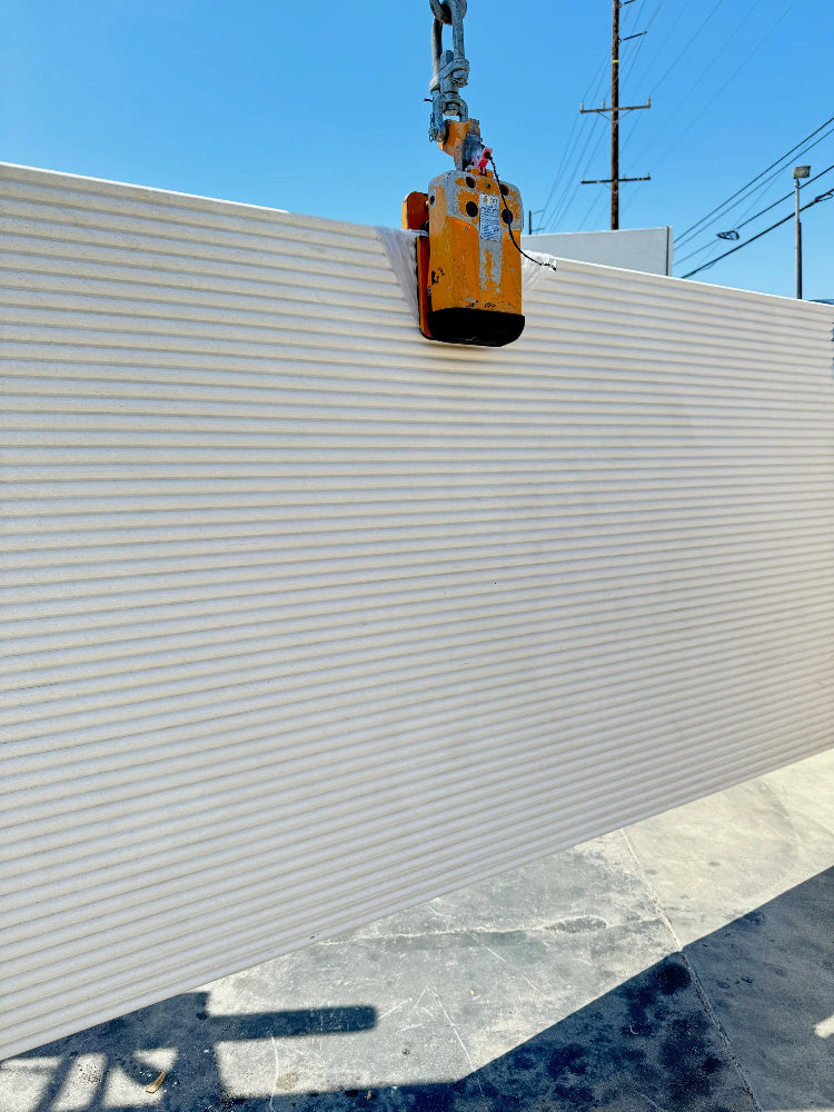 Close up of beige fluted limestone slab in Los Angeles stone yard