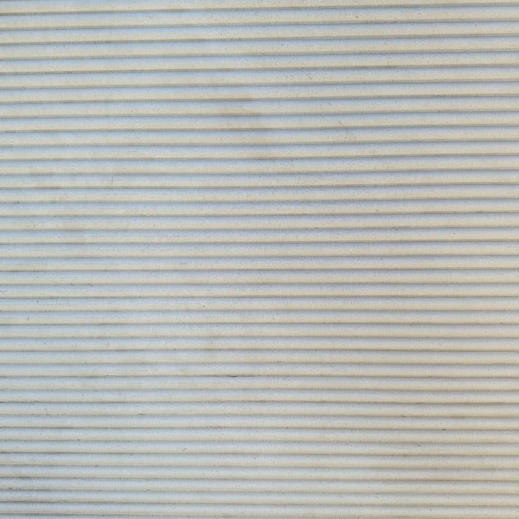 Details of beige fluted limestone slab in stock in Los Angeles slab yard