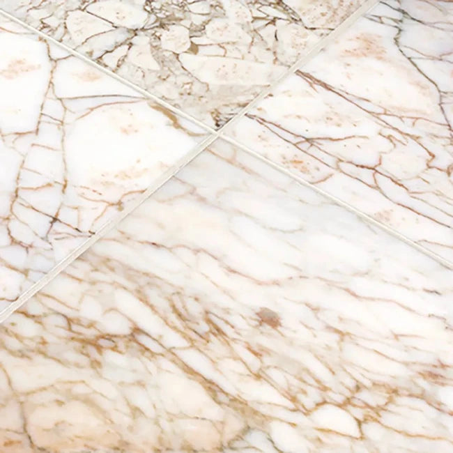 Close-up of marble-patterned tiles with beige and brown hues.