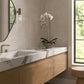 Modern bathroom with wooden vanity, marble countertop, and beige square wall tiles