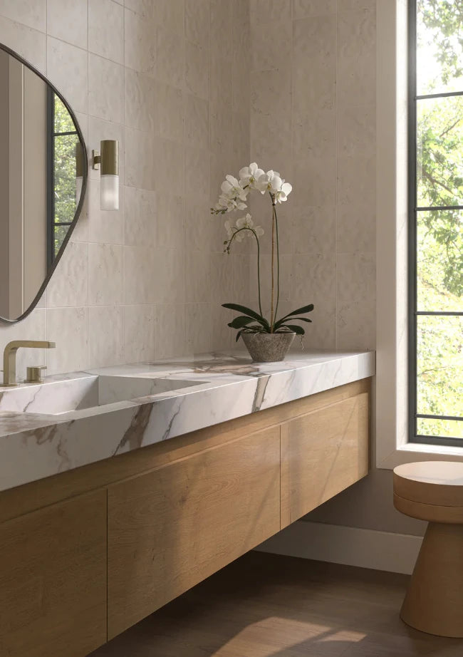 Modern bathroom with wooden vanity, marble countertop, and beige square wall tiles