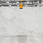 Large white marble slab with subtle veining in indoor slabyard