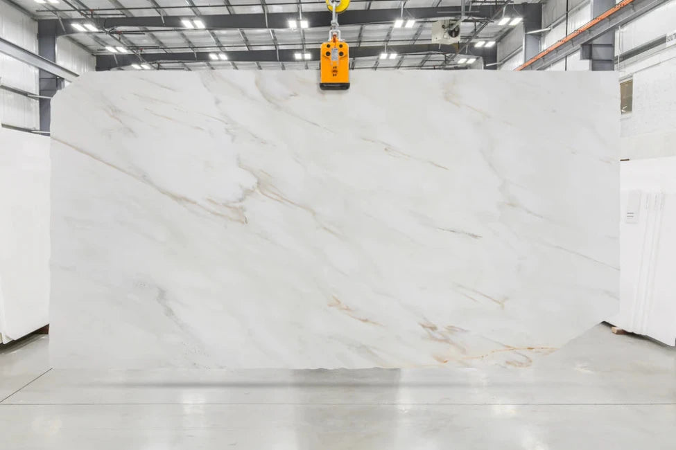 Large white marble slab with subtle veining in indoor slabyard