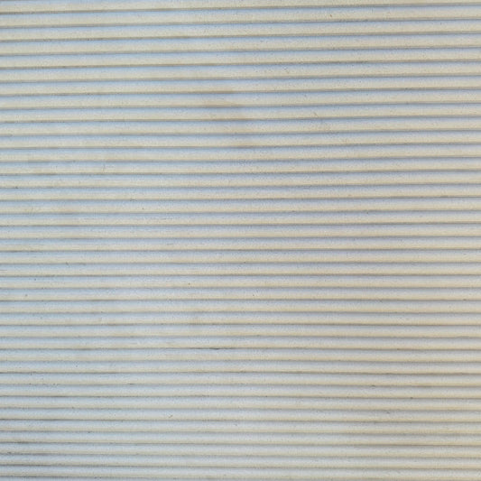 Details of beige fluted limestone slab in stock in Los Angeles slab yard