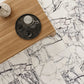 Marble-patterned tiles with a wooden surface and decorative items.