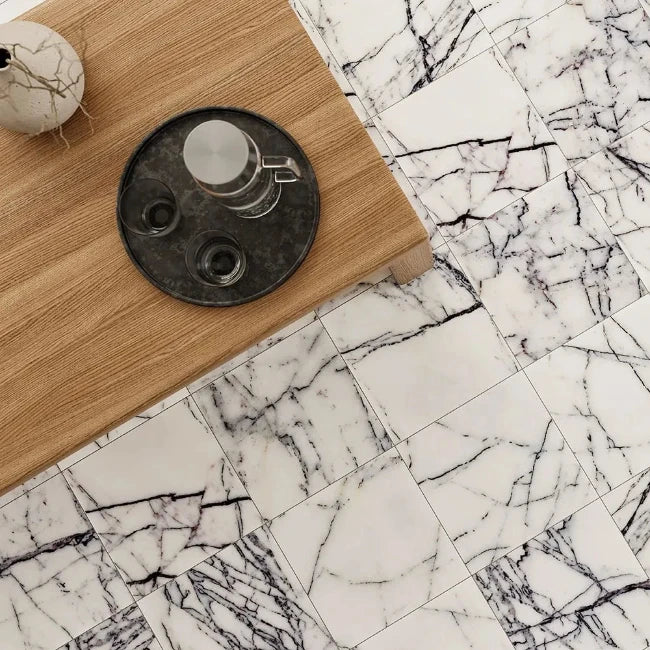 Marble-patterned tiles with a wooden surface and decorative items.