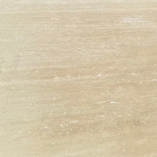 A closeup of a beige travertine stone slab.