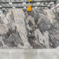 Large slab of marble with a gray and white pattern in indoor slab yard