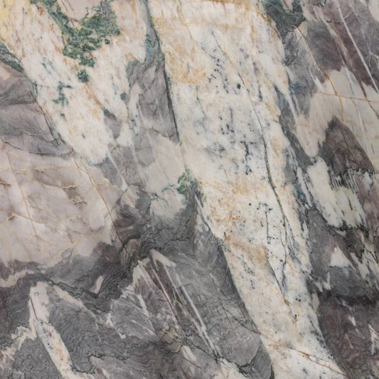 Close-up of a textured quartzite stone slab with varying shades of gray, beige, and brown.