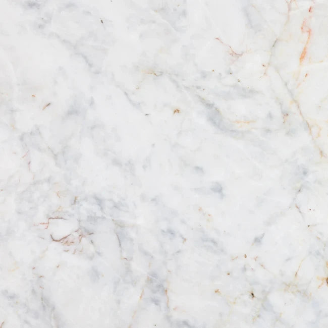 White marble slab with soft gray veining and subtle warm beige-brown veining throughout the surface.