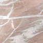 A close-up of a pinkish quartzite stone surface with white veining and a soft blush tone.