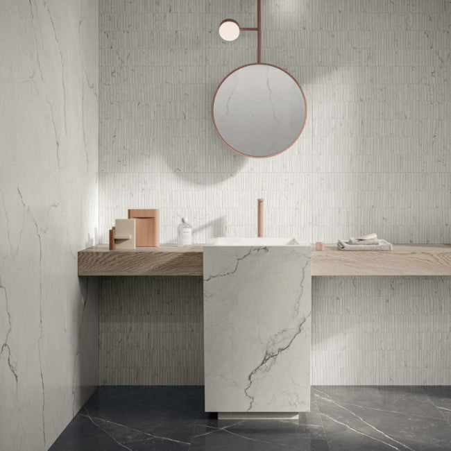 Modern bathroom with marble vanity and round mirror