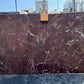 Marble slab with a maroon and white pattern in los angeles stone yard