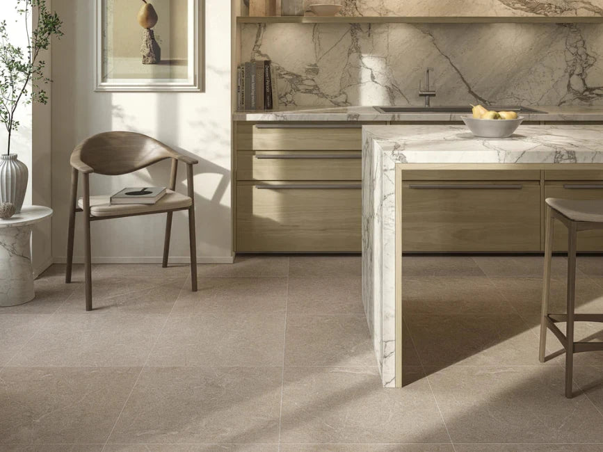 Modern kitchen with marble countertops and beige tiled floor