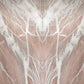 A symmetrical close-up of a pink quartzite stone with white veining and a vertical center seam running through the frame.
