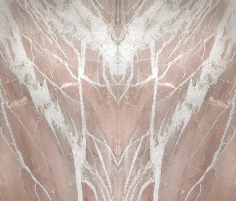 A symmetrical close-up of a pink quartzite stone with white veining and a vertical center seam running through the frame.
