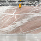 Large quartzite slab with pink and white veins in a warehouse setting