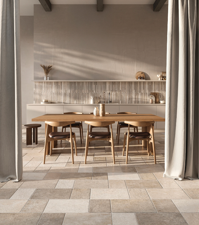 Dining area with wooden table and chairs in a modern kitchen and beige porcelain tiles.