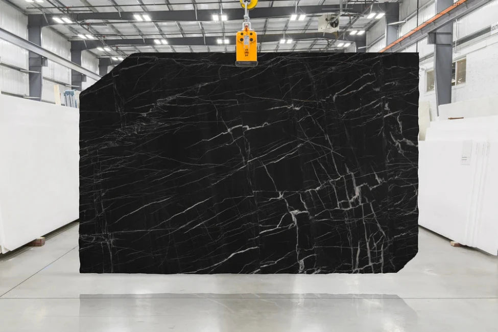 Black Quartzite slab with white veining in indoor slab yard